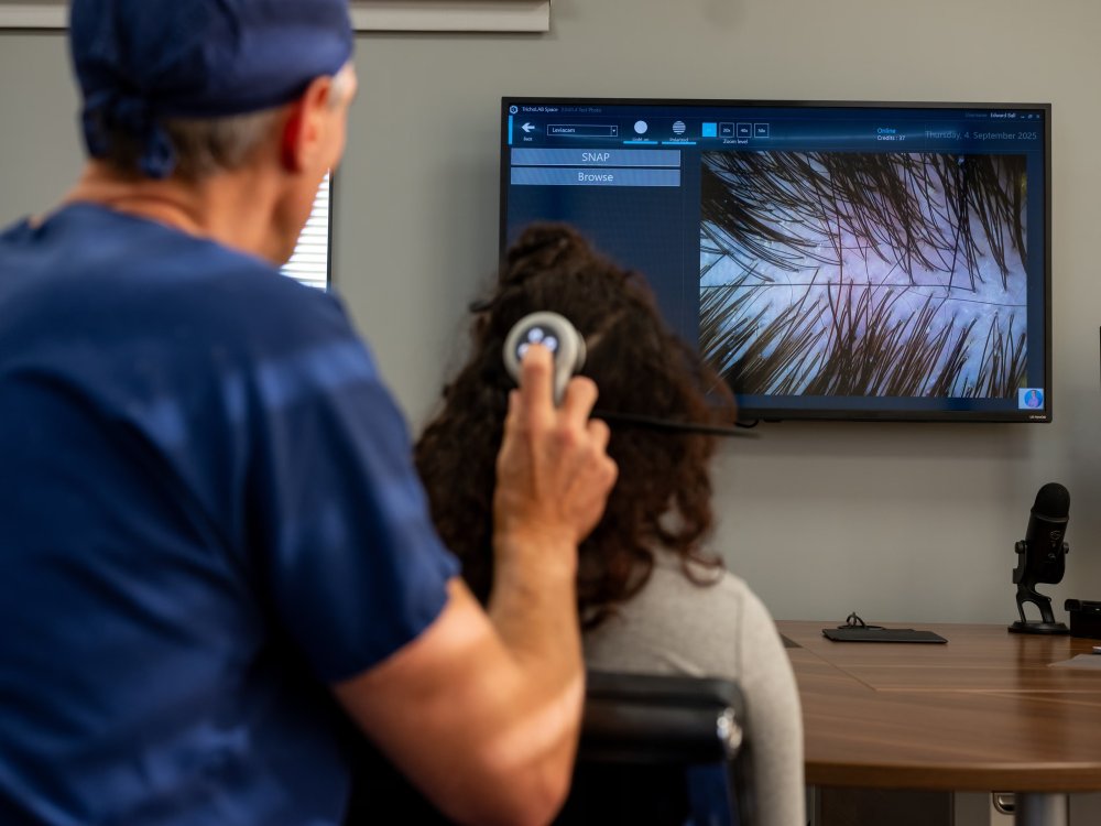Dr Ball examines Aria's scalp using high magnification video trichoscopy.